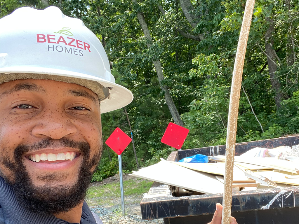 Beazer employee with hard hat on during a job site visit